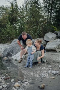 Eltern spielen mit ihrem kleinen Sohn am Ufer der Gail